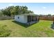 A detached shed is in a large backyard with room for projects and storage at 3100 Peacock Ln, Mulberry, FL 33860