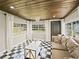 Cozy sunroom with black and white checkered flooring, ample windows, and a decorative chandelier at 3100 Peacock Ln, Mulberry, FL 33860
