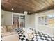 Sunroom with a checkerboard floor, bright windows, and comfortable seating adjacent to dining area at 3100 Peacock Ln, Mulberry, FL 33860