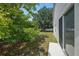 Cozy home backyard with a sliding glass door that leads into a private, tree-lined space at 442 Graystone Blvd, Davenport, FL 33837