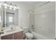 Clean bathroom with tiled shower over tub, single sink vanity, and decorative light fixture at 442 Graystone Blvd, Davenport, FL 33837