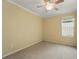 This carpeted bedroom offers a ceiling fan and a window allowing natural light at 442 Graystone Blvd, Davenport, FL 33837