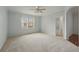 Bright bedroom featuring neutral carpet, a ceiling fan, and window for natural light at 442 Graystone Blvd, Davenport, FL 33837