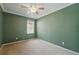 This carpeted bedroom offers a ceiling fan and a window allowing natural light at 442 Graystone Blvd, Davenport, FL 33837
