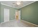 Green bedroom features neutral carpet, a ceiling fan, and a closet at 442 Graystone Blvd, Davenport, FL 33837