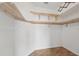 A large walk-in closet featuring custom wood shelving and cork flooring at 442 Graystone Blvd, Davenport, FL 33837
