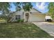 Charming single Gathering home featuring an attached two car garage and a manicured lawn at 442 Graystone Blvd, Davenport, FL 33837