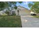 Charming single Gathering home featuring an attached two car garage and a manicured lawn at 442 Graystone Blvd, Davenport, FL 33837