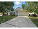 Charming single Gathering home featuring an attached two car garage and a manicured lawn at 442 Graystone Blvd, Davenport, FL 33837