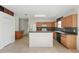 Spacious kitchen featuring wood cabinets, breakfast bar, and ample counter space for meal preparation at 442 Graystone Blvd, Davenport, FL 33837