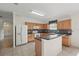 Bright kitchen boasts wood cabinetry, breakfast bar, tile floors, and a seamless layout for entertaining at 442 Graystone Blvd, Davenport, FL 33837