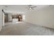 Open-concept living area features ceiling fan and seamless flow to kitchen for modern living at 442 Graystone Blvd, Davenport, FL 33837