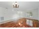 Bright living room featuring wood floors, a chandelier, and a large window for natural light at 442 Graystone Blvd, Davenport, FL 33837