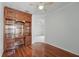 Bright office featuring hardwood floors and a custom wood built-in desk and shelving unit at 442 Graystone Blvd, Davenport, FL 33837
