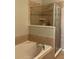Luxurious bathroom featuring a glass-enclosed shower and soaking tub with stylish tile work at 10303 Park Commons Dr, Orlando, FL 32832