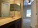 Bathroom featuring a single sink vanity, large mirror, and tile flooring at 10303 Park Commons Dr, Orlando, FL 32832