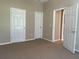 Bedroom with neutral walls and carpet, offering versatile use for a relaxing and private space at 10303 Park Commons Dr, Orlando, FL 32832