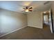 Bedroom with neutral walls, carpet flooring, and ceiling fan, offering a comfortable living space at 10303 Park Commons Dr, Orlando, FL 32832