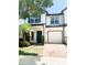 Charming home featuring brick drive, one car garage, blue shutters, and beautifully manicured lawn at 10303 Park Commons Dr, Orlando, FL 32832