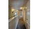 Hallway with neutral walls, carpet flooring, and multiple doorways to other rooms at 10303 Park Commons Dr, Orlando, FL 32832