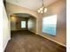 Inviting living room featuring fresh paint, carpet, arched doorways, and window with blinds at 10303 Park Commons Dr, Orlando, FL 32832