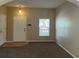 Inviting living room features fresh paint, carpet, window with blinds, and lots of space at 10303 Park Commons Dr, Orlando, FL 32832