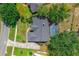 Aerial view of home with screened in pool; lush lawn and mature trees at 10421 Mesa Ln, Clermont, FL 34711