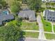 Aerial view of the home with a well-maintained lawn, mature trees and a long driveway at 10421 Mesa Ln, Clermont, FL 34711