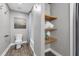 Bright bathroom featuring a tub/shower combo with custom shelves with vanity and commode at 10421 Mesa Ln, Clermont, FL 34711