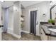 Bright bathroom featuring a tub/shower combo, storage shelves and granite countertops with dual sinks at 10421 Mesa Ln, Clermont, FL 34711