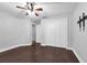 Bedroom with a window letting in natural light, smooth walls, and hardwood floors at 10421 Mesa Ln, Clermont, FL 34711