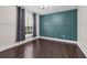 Bedroom with a window letting in natural light, smooth walls, and hardwood floors at 10421 Mesa Ln, Clermont, FL 34711