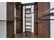 Spacious walk-in closet with custom wood shelving, racks, and dark wood floors offers ample storage at 10421 Mesa Ln, Clermont, FL 34711