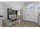 Elegant dining room with stylish lighting, seating for six, and seamless entry to the home office at 10421 Mesa Ln, Clermont, FL 34711