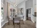 Bright dining area featuring a modern chandelier and large windows overlooking the pool at 10421 Mesa Ln, Clermont, FL 34711