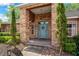Welcoming front entrance with a blue door, brick columns, and manicured greenery offering curb appeal at 10421 Mesa Ln, Clermont, FL 34711