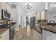 Bright kitchen with granite counters, stainless appliances, and wood-look tile flooring at 10421 Mesa Ln, Clermont, FL 34711