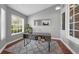 Well-lit office space with a modern desk, large window, and neutral color scheme creating a productive environment at 10421 Mesa Ln, Clermont, FL 34711