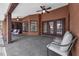 An outdoor covered patio with ceiling fans and seating offers a relaxing space to entertain at 10421 Mesa Ln, Clermont, FL 34711