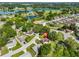 Aerial view of a neighborhood with a lake, showcasing a home with solar panels at 1110 Waterview E Blvd, Lakeland, FL 33801