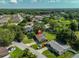 Aerial view of home, neighborhood and mature trees on an oversized lot; solar panels on roof at 1110 Waterview E Blvd, Lakeland, FL 33801