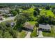 Aerial view of home, showcasing solar panels, lush surroundings, mature trees, driveway and adjacent homes at 1110 Waterview E Blvd, Lakeland, FL 33801