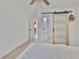 Comfortable bedroom with ceiling fan and bathroom access through sliding door at 1110 Waterview E Blvd, Lakeland, FL 33801