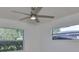 A bedroom with light walls, two windows offering views, and a ceiling fan at 1110 Waterview E Blvd, Lakeland, FL 33801
