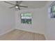 Bright bedroom features wood-look floors, a ceiling fan, and natural light from the window at 1110 Waterview E Blvd, Lakeland, FL 33801