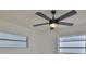 Bright bedroom enhanced by a ceiling fan and natural light from the two windows at 1110 Waterview E Blvd, Lakeland, FL 33801
