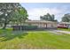 Charming single-story home with a well-manicured lawn and mature trees at 1110 Waterview E Blvd, Lakeland, FL 33801