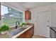 Kitchen features granite countertops, a stainless steel sink, and a view of the backyard at 1110 Waterview E Blvd, Lakeland, FL 33801