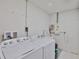 Bright laundry room featuring washer, dryer, sink, and storage at 1110 Waterview E Blvd, Lakeland, FL 33801