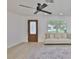 Bright living room featuring a ceiling fan, large window, and stylish area rug at 1110 Waterview E Blvd, Lakeland, FL 33801
